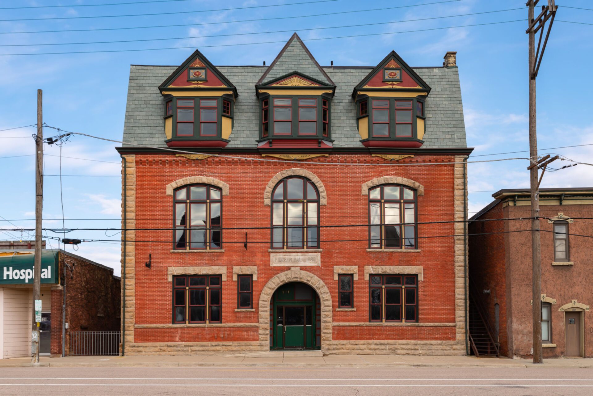 Historic red brick building with arched windows.